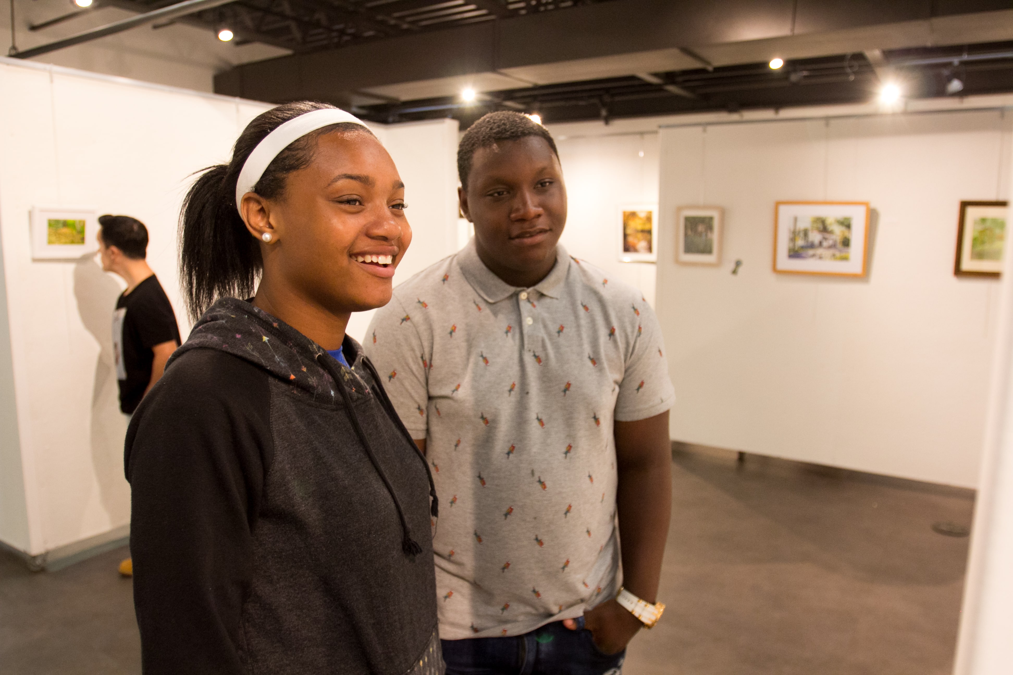 two pictures looking at a painting in the art gallery